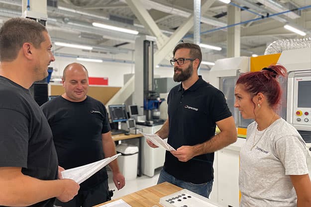 Cimcoop team discussing production on the factory floor